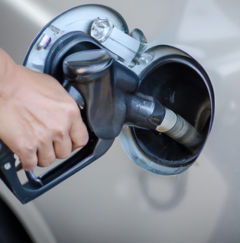 A Closeup of a pump in a man hand filling petrol